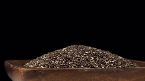 Chia Seeds in a Wooden Bowl on Black