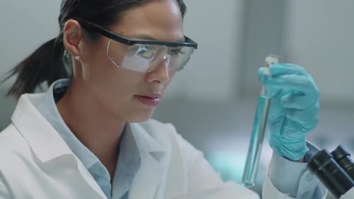 Woman Scientist Examining Test Tube in Laboratory