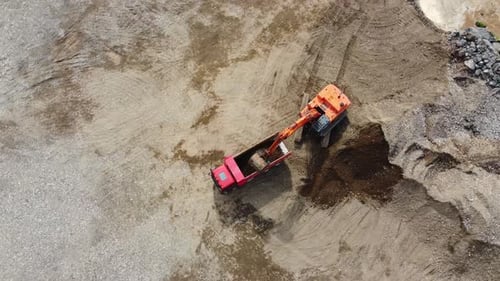 Excavator Loading Soil into Truck Aerial View