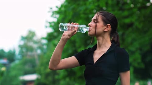 Exhausted and Sweating Caucasian Woman Resting After a Hard Workout in the Gym or Exercise Outdoors