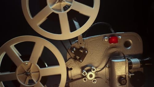 Vintage Film Projector Playing Movie Reels