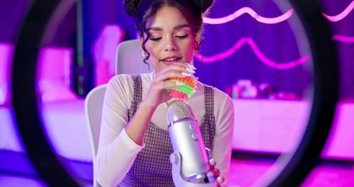 Woman Records ASMR in Neon Lit Studio