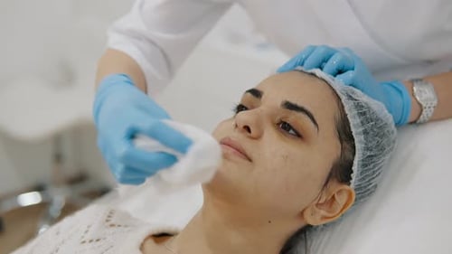 Woman Receiving Facial Treatment at Clinic