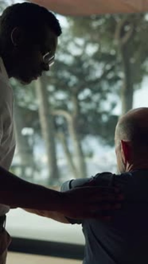 Man Giving Senior Man Shoulder Physical Therapy