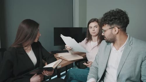 Team collaboration in the office with colleagues discussing ideas and taking notes during a meeting