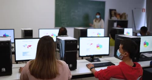 Students Learning Computer Skills in Modern Classroom