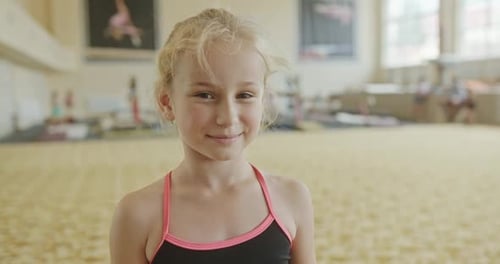 Little Cheerful Girl in Gymnasium