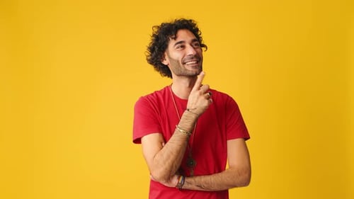 Pensive man thinking something, having good idea isolated on yellow background in studio