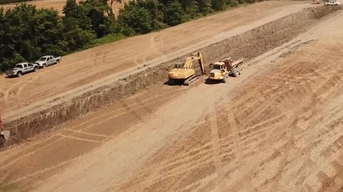 Heavy Equipment Digging Trench in Rural Landscape