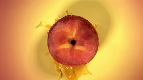 Peach Being Splashed With Golden Juice