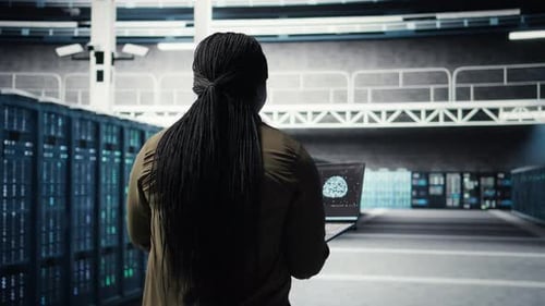 Engineer in Server Hub Using Laptop to Upgrade Rigs Using AI Deep Learning