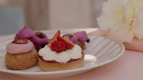 Delicious Pastries with Strawberries and Cream on Plate