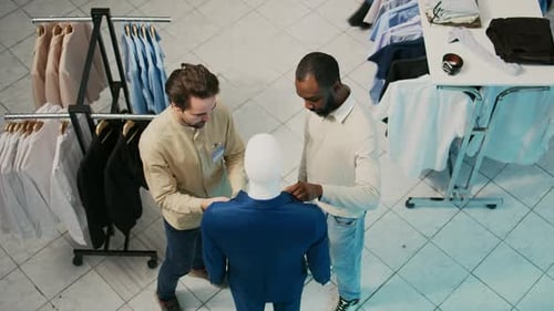 Store Assistant and Client Looking at Formal Suit on