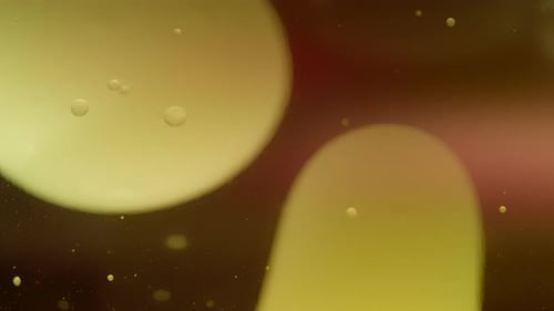 Abstract yellow lava bubbles floating in liquid on gradient orange background