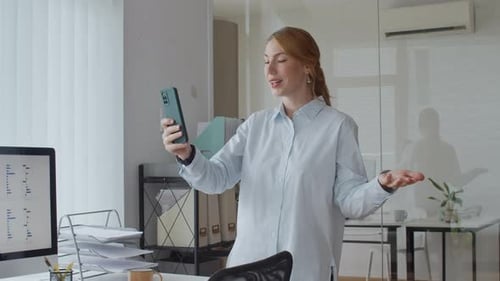 Financial Manager Talking on Video on Smartphone at Office