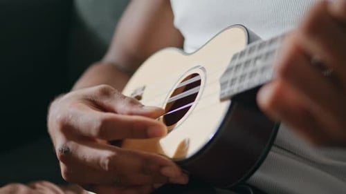 Close up of Ukulele Being Played
