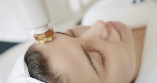 Young Woman Receiving Forehead Treatment in Hospital