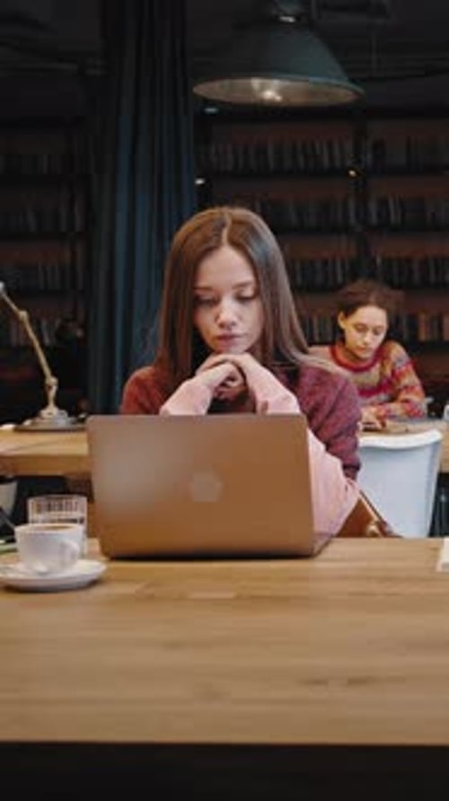 Focused Millennial Students of International University Studying Remotely at Library