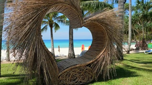 Tropical Beach View Through Unique Wooden Structure with Palm Trees