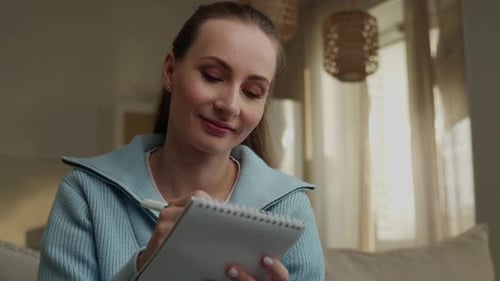 Woman Writing in Notebook