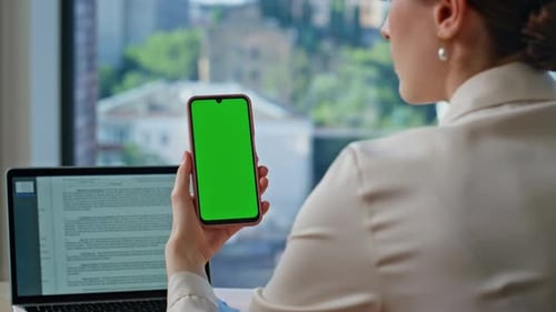 Business Lady Browsing Chroma Key Smartphone in Office Workspace Closeup