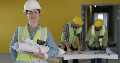 Woman, face and engineering at construction site, planning building and teamwork