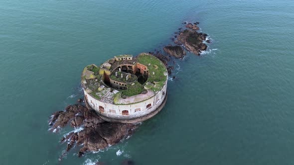 Stack rock fort aerial view circling above Milford Haven small island ...