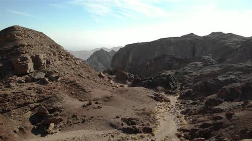 Aerial footage over large rocks and cliffs in the desert