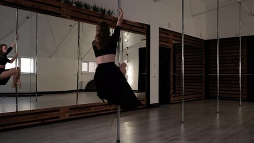 Athletic Young Woman Performs Tricks on Pylon Pole Dancer Does Acrobatic Elements Modern Sport and