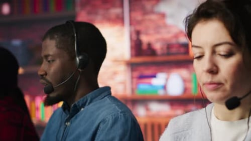Call Center Employees Wearing Headset Assisting Customers in Office Close Up