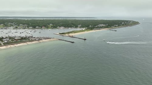 Drone shot, boat entering a marina in Cape Cod, Massachusetts.