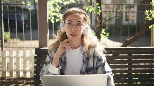Young Woman Smiling During Online Video Call Outdoors