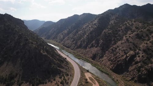 Mountain stream flow among the rocky mountains, along the road