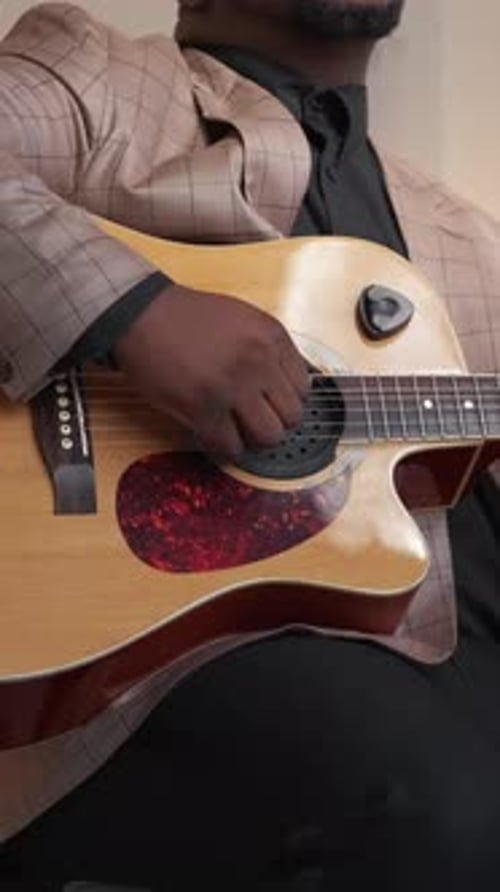 Musician Playing Acoustic Guitar Indoors