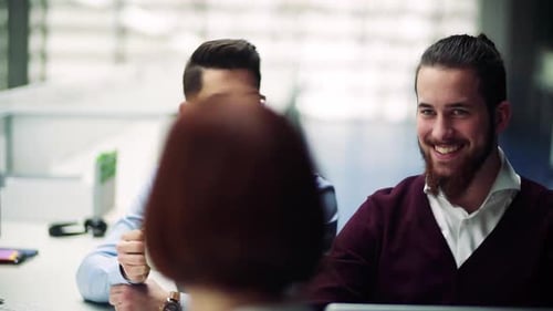 Group of Young Businesspeople with Coffee in Office, Talking