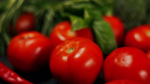 Closeup Red Tomatos with Green Leaves in Basket Closeup Delicious Organic Healthful Nutritious Food