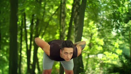 Man Doing Fitness Exercises Outdoor. Fit Man Stretching in Park. Outdoor Fitness