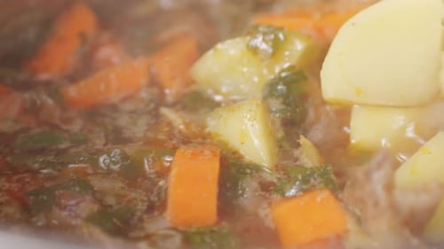 Hungarian Goulash Soup Cooking Closeup in Pot Chef Cook Traditional Polish or Zech Soup in