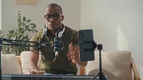 Man Plays Digital Piano and Records Video