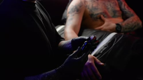 Tattoo Artist Prepares Tattoo Machine for Tattooing