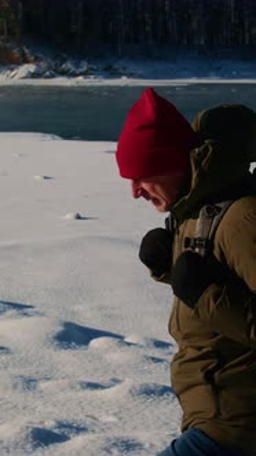 Man Walking in Snowy Winter Landscape