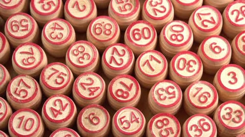 Lotto board game with wooden barrels with numbers close up rotate background top view sun light