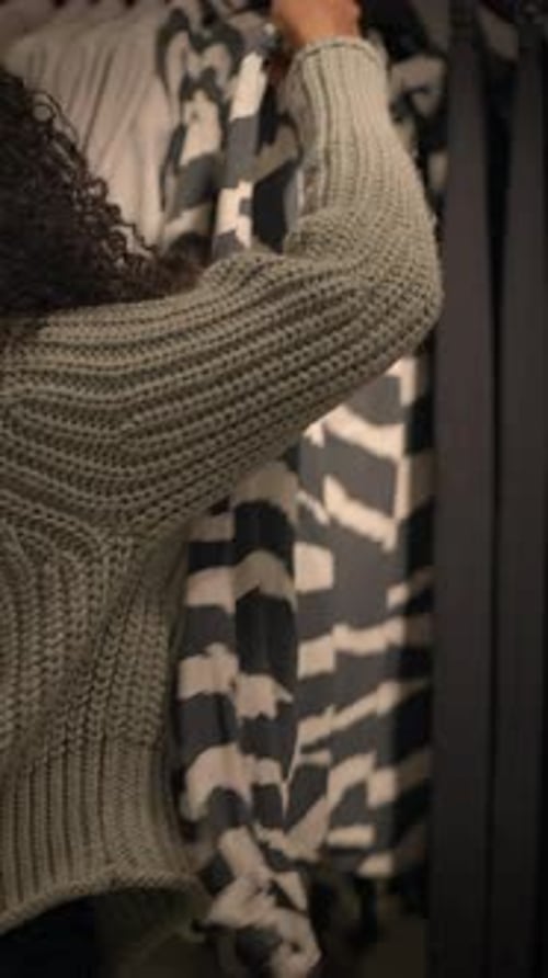 Woman Shops For Clothes in Retail Clothing Store