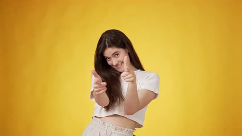 Enthusiastic Young Woman Posing and Gesturing Cheerfully