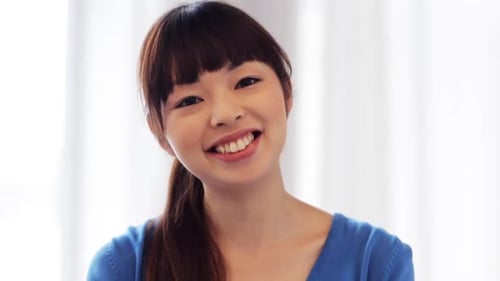 Smiling young woman with dark hair in studio