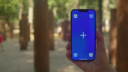 Young Woman Holding Phone Chroma Key Screen in Front of Playground Closeup Girl with Green Screen on