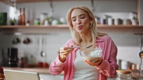 Woman Eating Cereal and Dancing in Kitchen