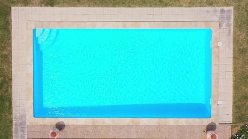 Top View of an Empty Swimming Pool for Relaxation in Garden with Green Grass
