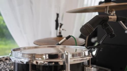 Closeup Tracking Shot of Professional Microphone Capturing Sound of Drum Set Ready for Music