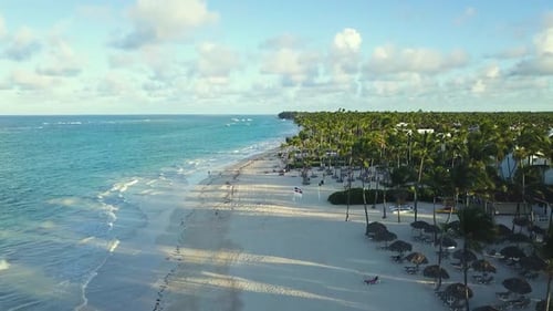 Aereal fly over drone shot over bávaro beach high angle looking down gently waves in a calm sunny su